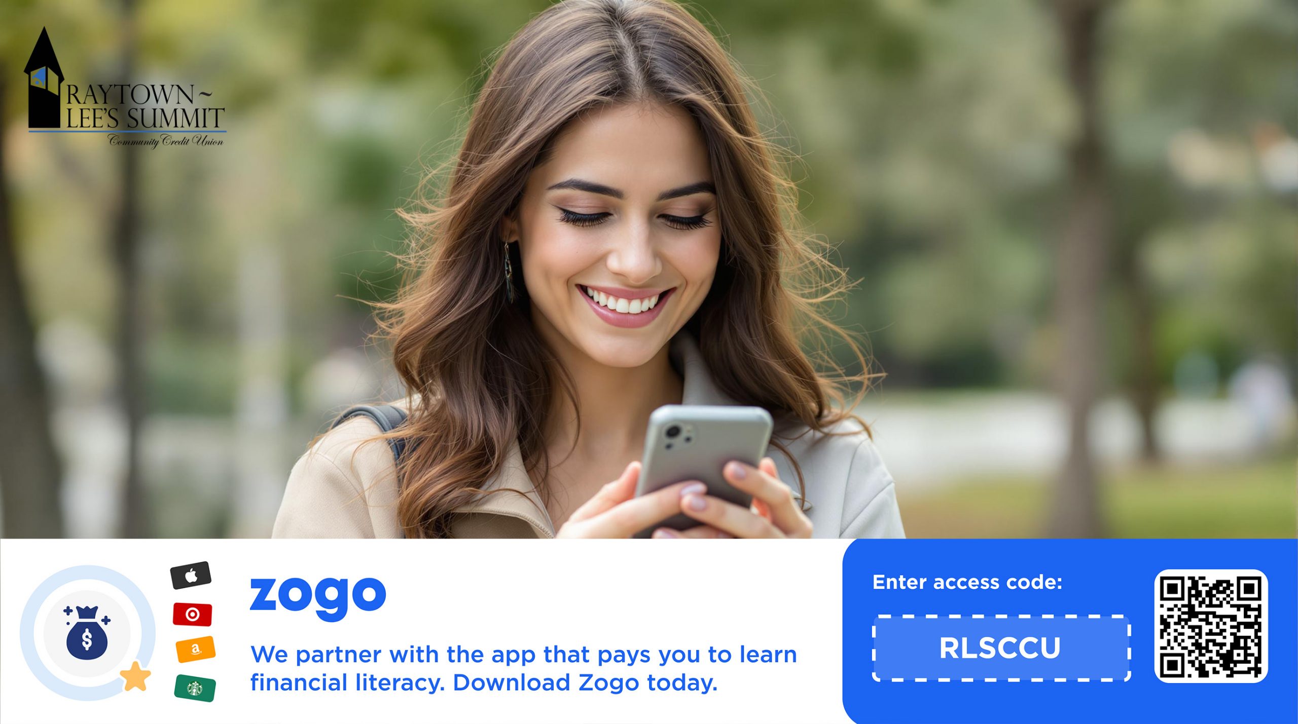 A banner image promoting the Zogo app. The top portion shows a young woman with long brown hair smiling while looking at her smartphone outdoors, with blurred green trees in the background. The upper left corner features the logo for "Raytown-Lee's Summit Community Credit Union." The lower portion of the image has a blue and white design with Zogo's logo and icons of gift cards (Apple, Target, Amazon, Starbucks). The text reads: "We partner with the app that pays you to learn financial literacy. Download Zogo today." To the right, there is a QR code and the text "Enter access code: RLSCCU" inside a dotted blue box.